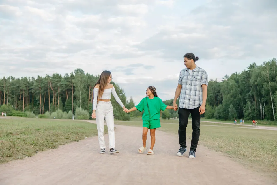 Parents and a child walking together outdoors